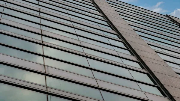 Panorama Nubes hinchadas blancas Vista de ángulo bajo de una fachada de edificio en ascenso con vidrio reflectante w — Foto de Stock