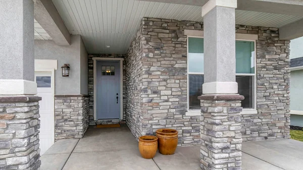 Panorama House exterior with stone veneer siding and garage