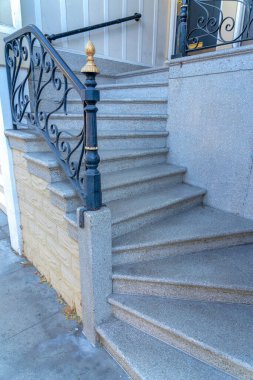 San Francisco, Kaliforniya 'da demir parmaklıklı beton merdivenler. Süslü parmaklıkları ve duvara monte edilmiş tırabzanları olan bir kapı eşiğinin yan görüntüsü..