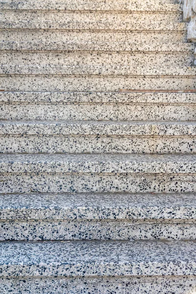 Granite steps of an outdoor staircase at San Francisco, California. Close-up of a stairs with concrete treads and risers with black and white colors.