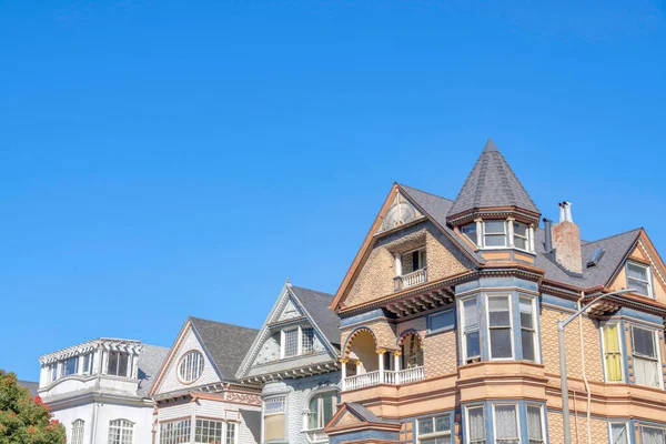 Roof of french country houses against the clear blue sky in San Francisco, California. Residential building structures with ornate trimmings.