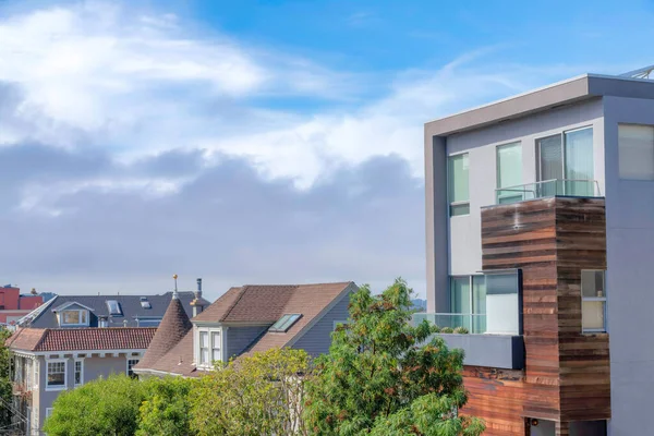 Multi-storey single-family houses in San Francisco, California. High angle view of residential buildings with modern, french country, and traditional exterior designs against the cloudy sky.