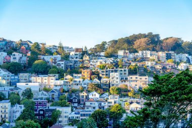 High angle view of sloped residential area at San Francisco, California. Facade of residential buildings on a mountain against the sky background.