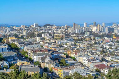 Dense urban area at downtown San Francisco, California. Aerial view of dense houses and skyscraper buildings against the skyline background.