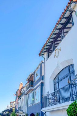 Row of houses with modern and mediterranean style exterior at San Francisco, California. Adjacent houses with reflective picture windows and decorative trims.