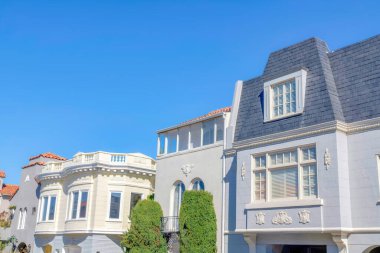 Row of houses with decorative wall exterior at San Francisco, California. Facade of adjacent houses with decorative trims and wall designs.