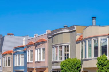 Side view of adjacent homes with curved window walls in San Franciso, California. Different front exterior of houses sash windows.