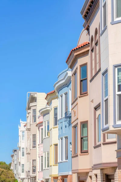 Row of townhouses and apartment buildings at San Francisco, California. There are three-storey townhouses at the front and low-rise apartment flats at the back with emergency stairs at the front.