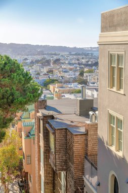 High angle view of residential area at San Francisco, California. There is a row of houses at the front against the dense houses at the back.