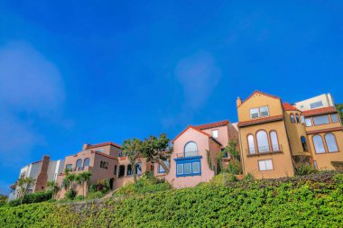 San Francisco Califronia 'da renkli evleri olan manzaralı bir ev. Güneşli bir günde mavi gökyüzü sırt çantalı bir mahalledeki evler..