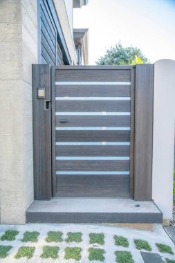 Del Mar Güney Kaliforniya 'da cam panelli ahşap kapı. Arka planda parlak gökyüzü manzarasına karşı kapalı kapısı olan bir eve giriş.