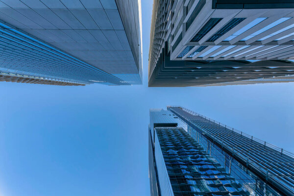 Looking up from the street at buildings and clear blue sky in Austin Texas. Architectural views of skyscrapers with modern design against skyscape background.