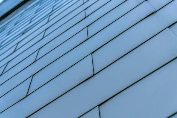 Exterior view of a building with close up on the wall with geometric design. Facade of a building with smooth texture and geometrical pattern style seen in downtown Austin Texas.