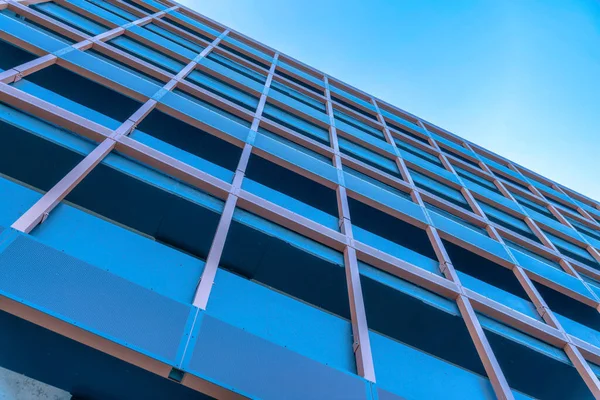 stock image Looking up at a modern building in the city with cloudless blue sky background. Exterior view of skyscraper in downtown Austin Texas with balconies at the facade.