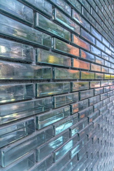Austin, Texas- Close-up of a building wall with glass bricks in a running bond pattern. Building exterior with reflective glass wall.