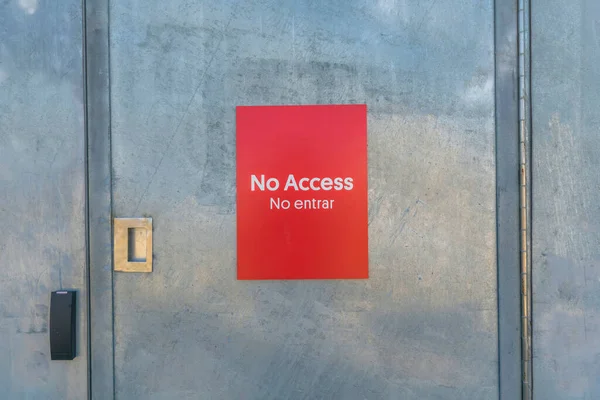 No Access signage on the door of a building at Waterloo Park Austin Texas. Close up view of a bright red sign that prohibits visitors to enter an area not open for public at a park.