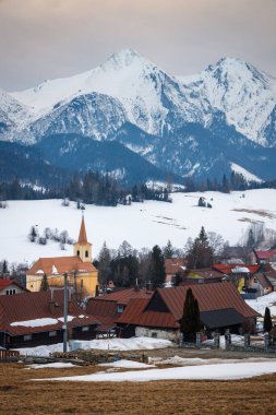 Kışın arka planında dağlardan oluşan bir panorama olan Zdiar köyünün halk mimarisi. Yüksek Tatras Ulusal Parkı, Slovakya, Avrupa.