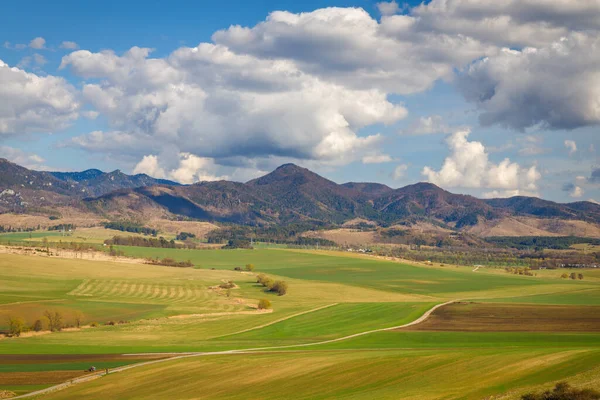 Sunny spring rural landscape, valley of fields and meadows with mountains in the background. Turiec Valley in Slovakia, Europe.