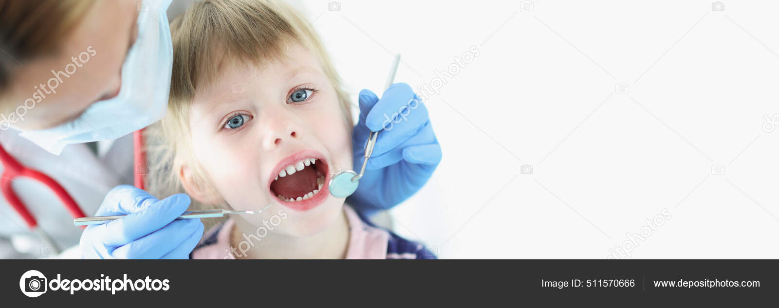 Dentist conducts medical examination of teeth of little girl Stock