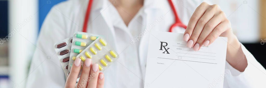 Doctor holds in his hand jar of pills and prescription form