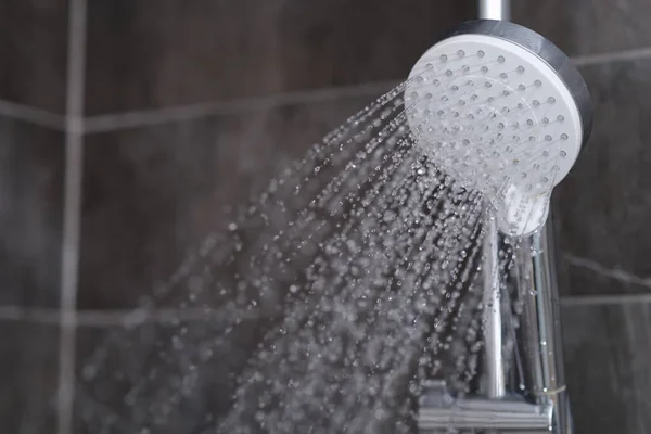 Rinnande vatten häller från förkromad duschblandare närbild — Stockfoto