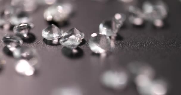 Scattering of precious transparent stones on black background 4k movie — Stock Video