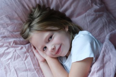 Joyful girl getting ready to sleep, close-up clipart