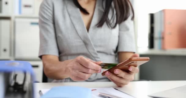 Woman applying credit bank card to mobile phone and making payment 4k movie — Stock Video