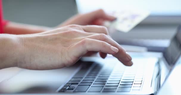 Woman is typing on keyboard and holding credit bank card slow motion 4k movie — Stock Video