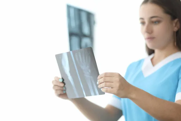 Traumatologista médico olhando para raio-x da mão em closeup clínica — Fotografia de Stock