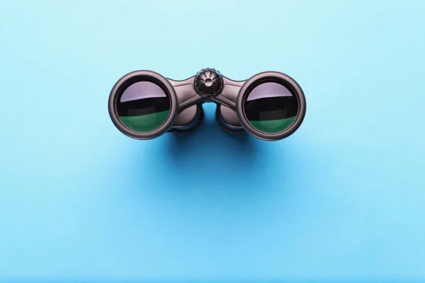 Binoculars equipment placed on blue background with shadow — Stock Photo, Image