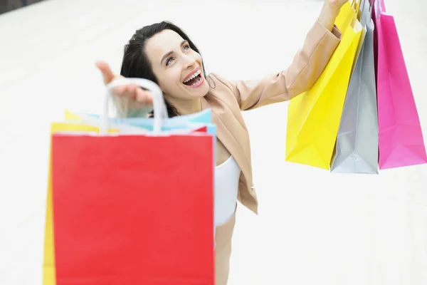 Ung kvinna shopaholic skrattar och vara glad över köpta saker — Stockfoto