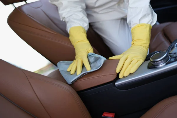 Osoba w rękawiczkach ochronnych i jednolitym, czystym samochodzie z antybakteryjną ściereczką — Zdjęcie stockowe