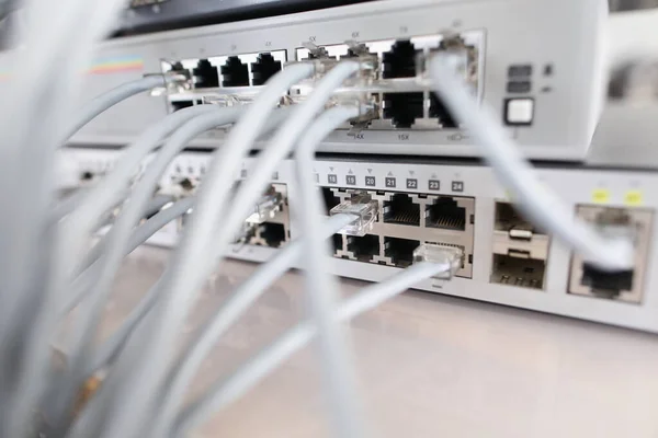 Set of cable network connected to internet switch servers in center — Stock Photo, Image