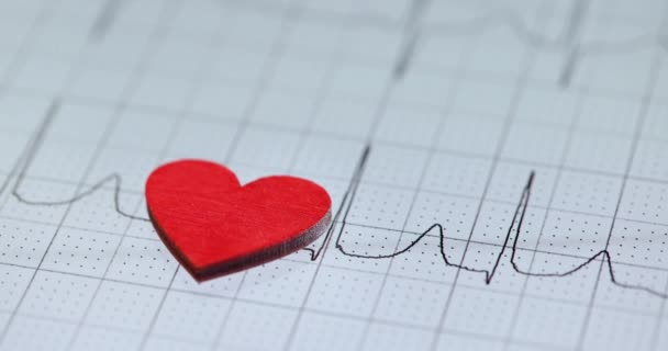 Rouge petit coeur repose sur cardiogramme ralenti film 4k — Video