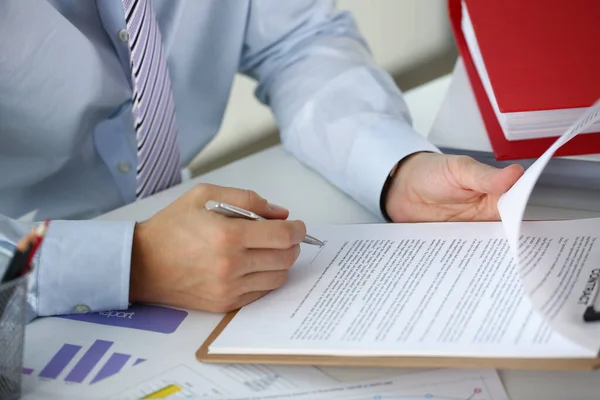 Businessman in the office signs a contract, close-up Stock Photo