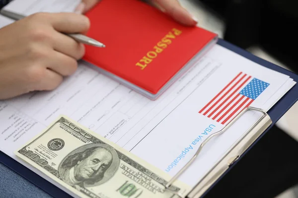 Visa application form paper with country national flag, passport and banknote