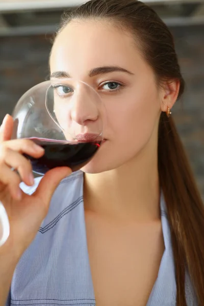 Female drinking red wine from glass and enjoying tasty drink — Fotografia de Stock
