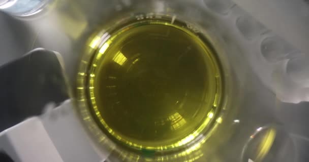 Liquid oily yellow-green solution in flask. and tool industry — Video Stock