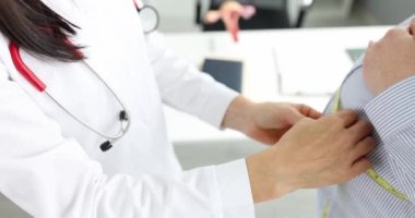 Doctor gynecologist measuring waist of pregnant woman using measuring tape in clinic 4k movie slow motion