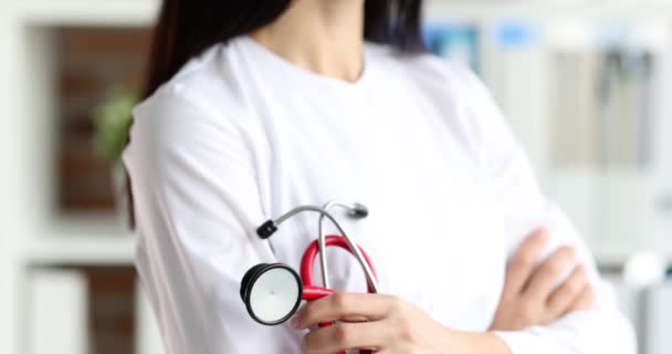 Smiling female doctor holding red stethoscope in clinic 4k movie slow motion — Vídeo de Stock