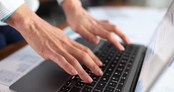 Female hands typing on computer keyboard at table in office closeup 4k movie slow motion — Stockvideo