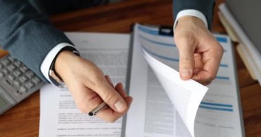Manager scrolling through documents and showing where to sign closeup 4k movie slow motion