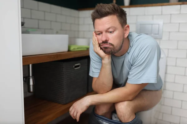 Bored man on toilet seat dream about something, fulfill natural need — Φωτογραφία Αρχείου