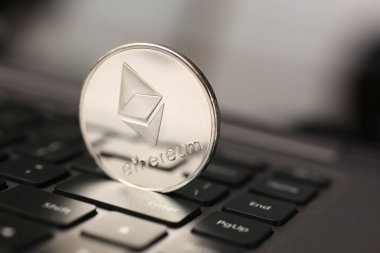 Ethereum silver coin on laptop pc keyboard