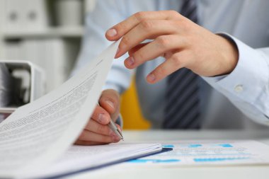 Male hands hold documents with financial statistics in closeup