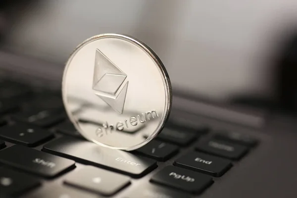 Ethereum silver coin on laptop pc keyboard — Stockfoto