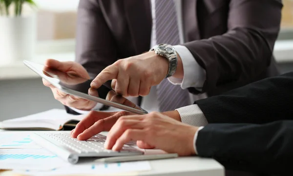 Two businessmen are looking and studying business statistics on tablet display — Zdjęcie stockowe