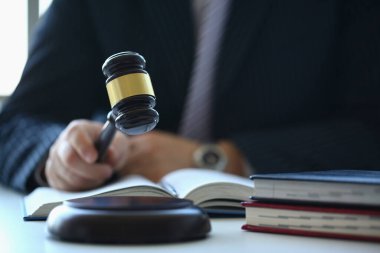 Male judge in courtroom hits with hammer