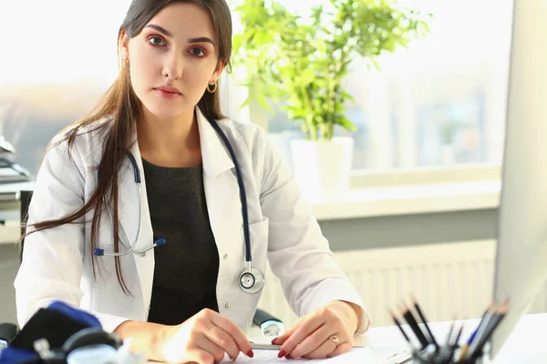 Woman doctor in medical gown at workplace — Foto Stock